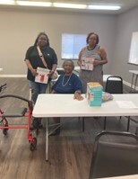 Three women with prizes from the Food Smart Classes.