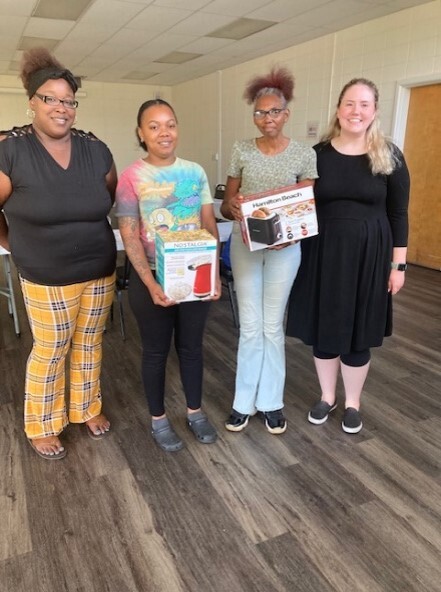 Two DEPC volunteers with two prize winners from the Food Smart classes.