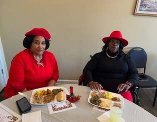 Two ladies sitting at a table.