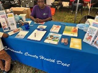 A woman sitting at a blue table.