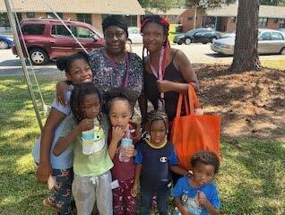 A family with children standing together for a photo.