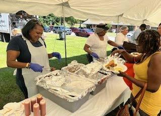 Individuals serving food.