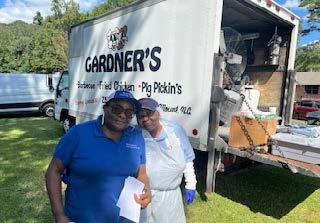 Two individuals standing by a truck.