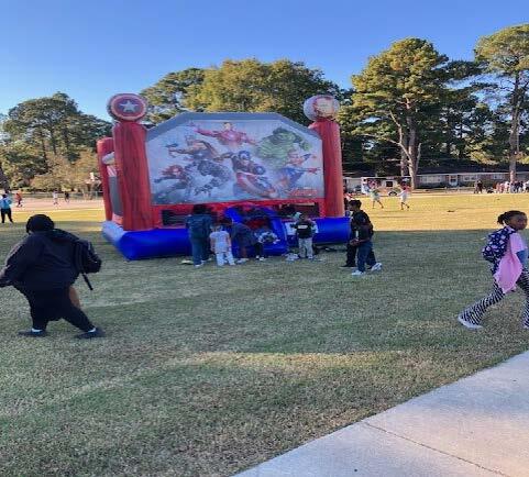 Children playing on a bounce house.