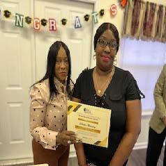 Two women holding an award.