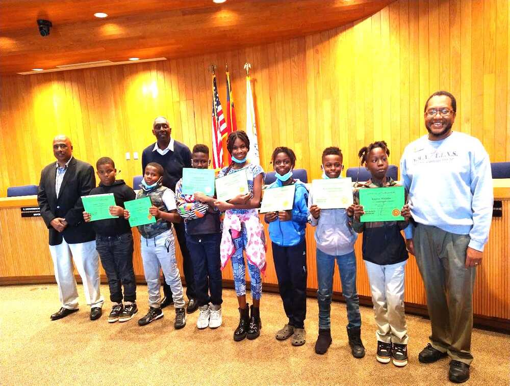 A large group of people holding various awards.